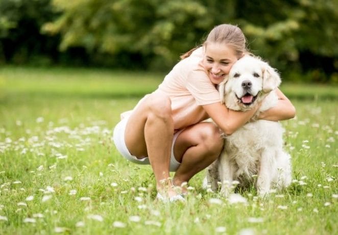 Start by giving your dog a big hug!