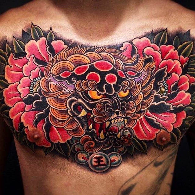 Foo dog and flower tattoo